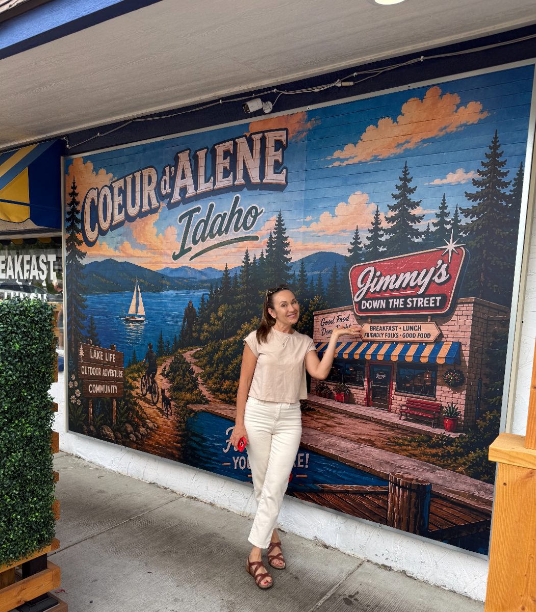 Anna in front of the Coeur d'Alene, Idaho mural featuring Jimmy's Down the Street