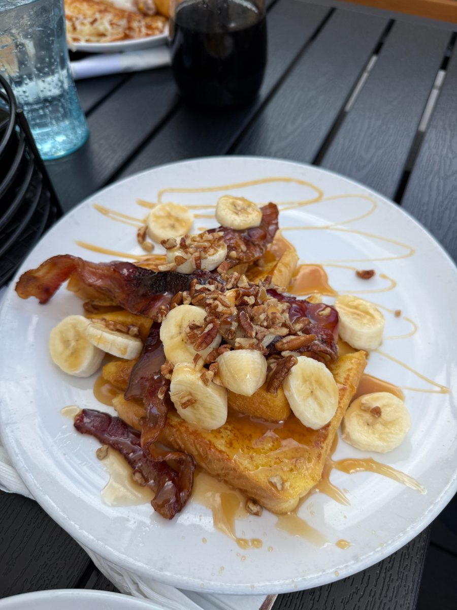 Banana nut French toast with sliced bananas, pecans, bacon and syrup