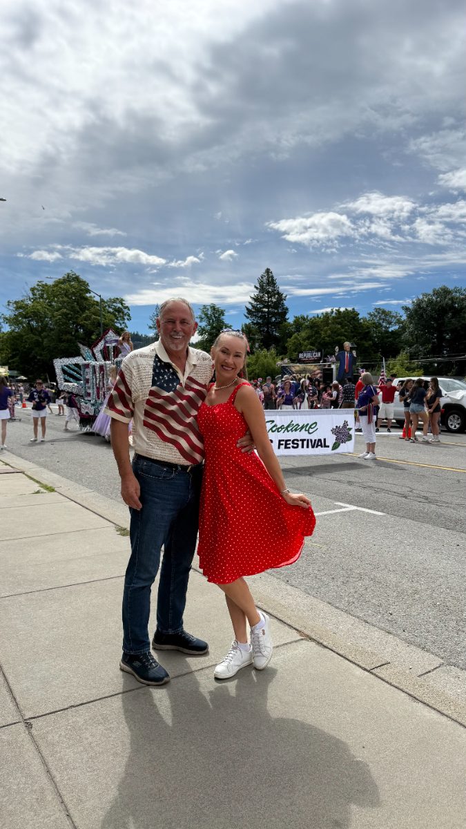 Jimmy and Anna smiling on Sherman Ave during a summer parade