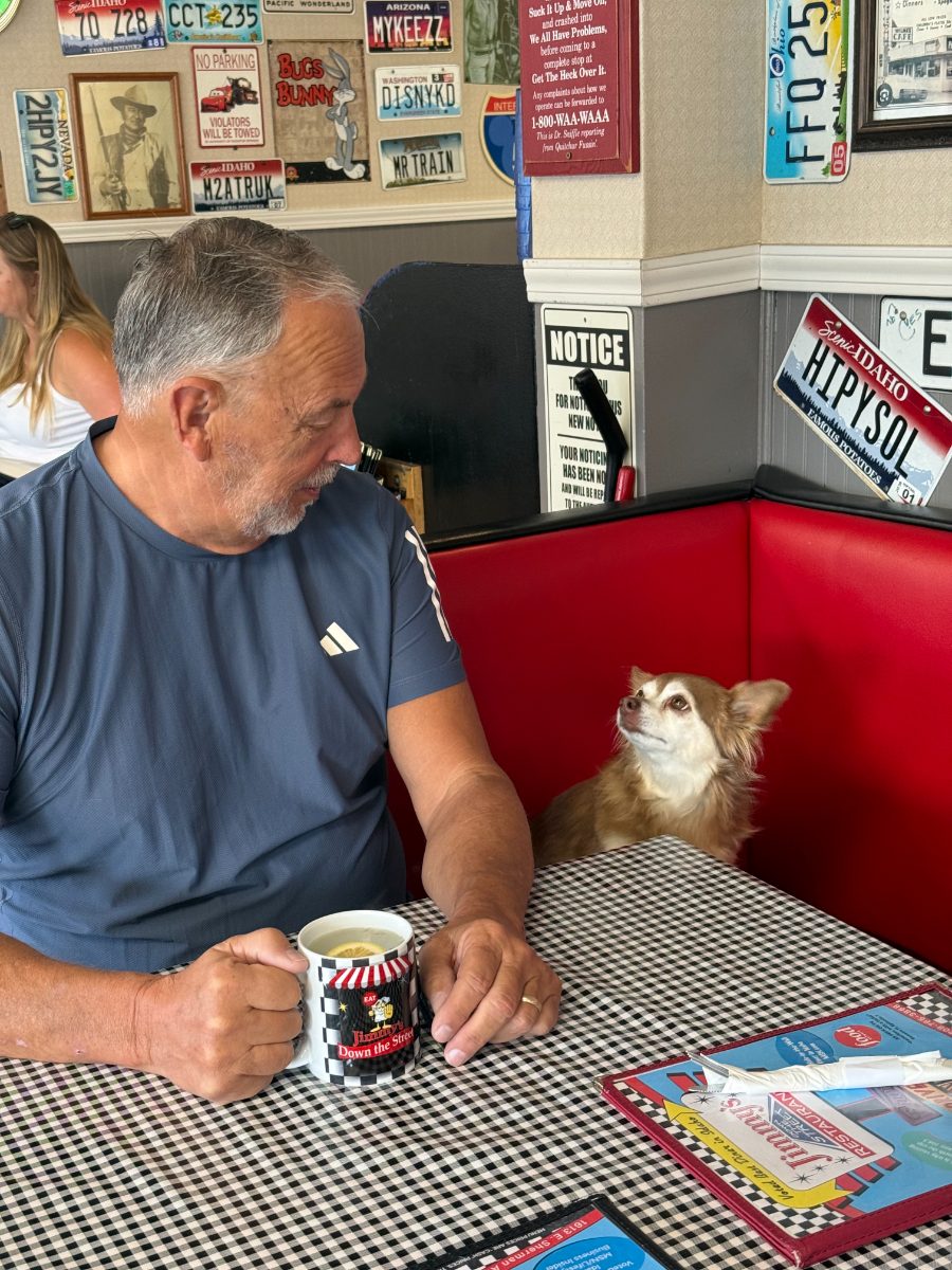 Jimmy with his Jimmy's mug and his pal Peanut the dog in a red booth