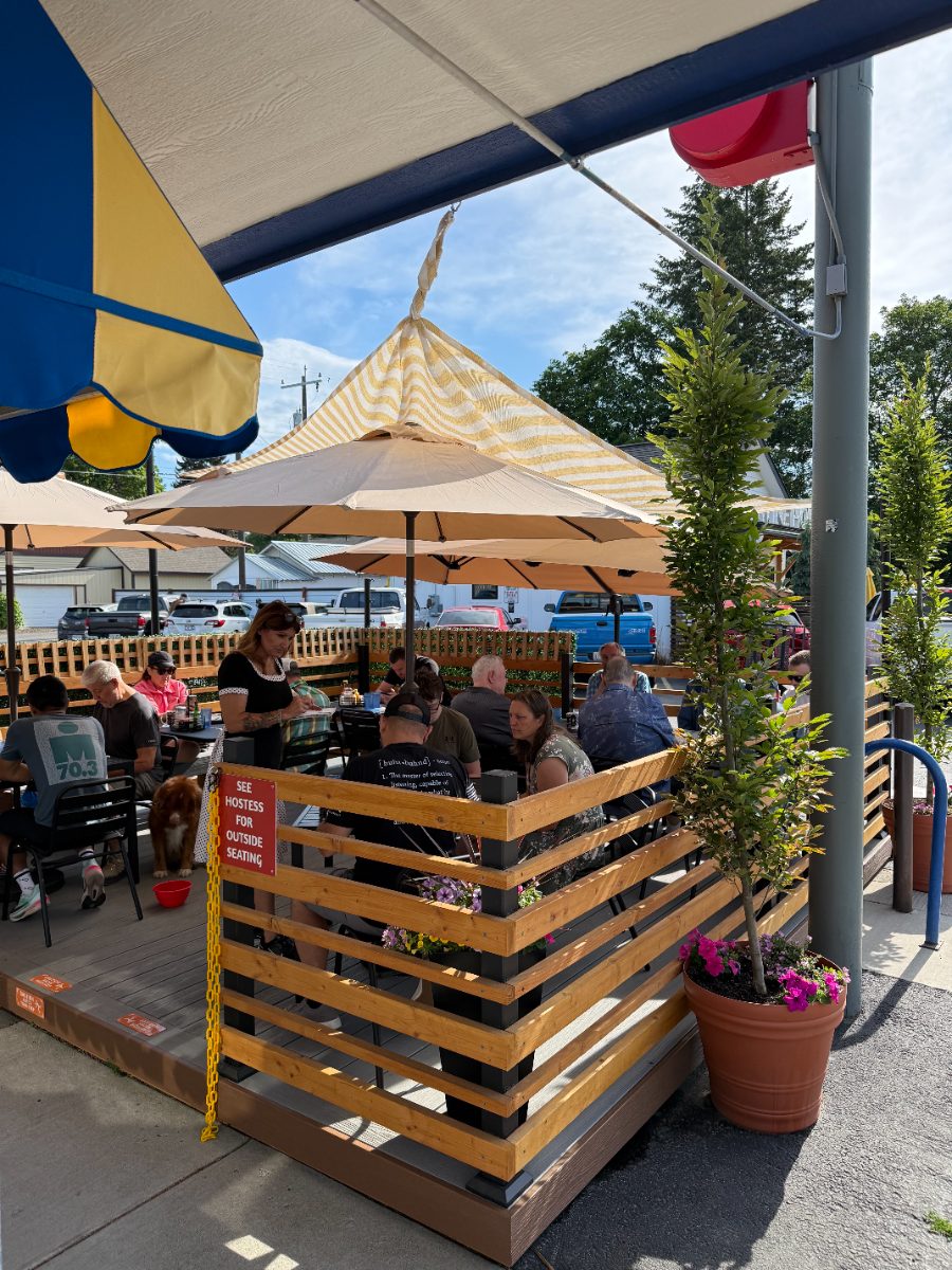 A busy morning on Jimmy's patio under umbrellas and the striped awning